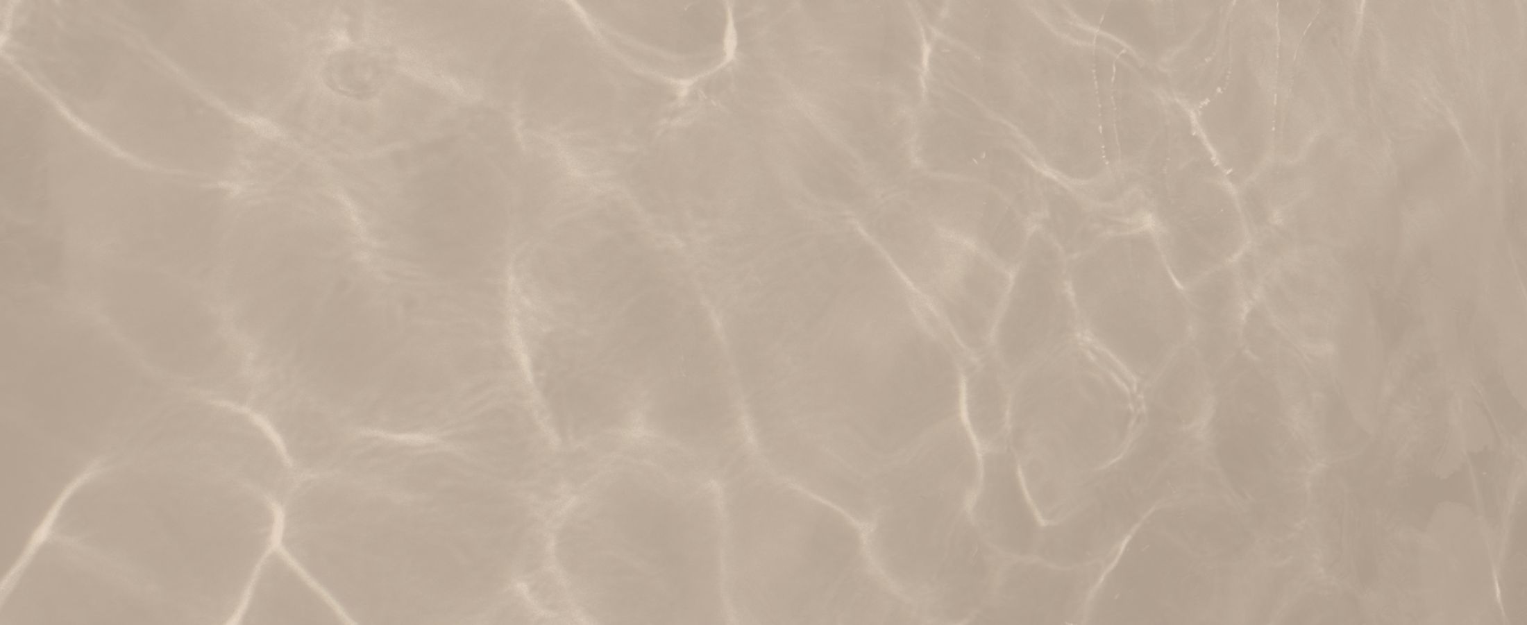 Calm water surface with abstract circle design.