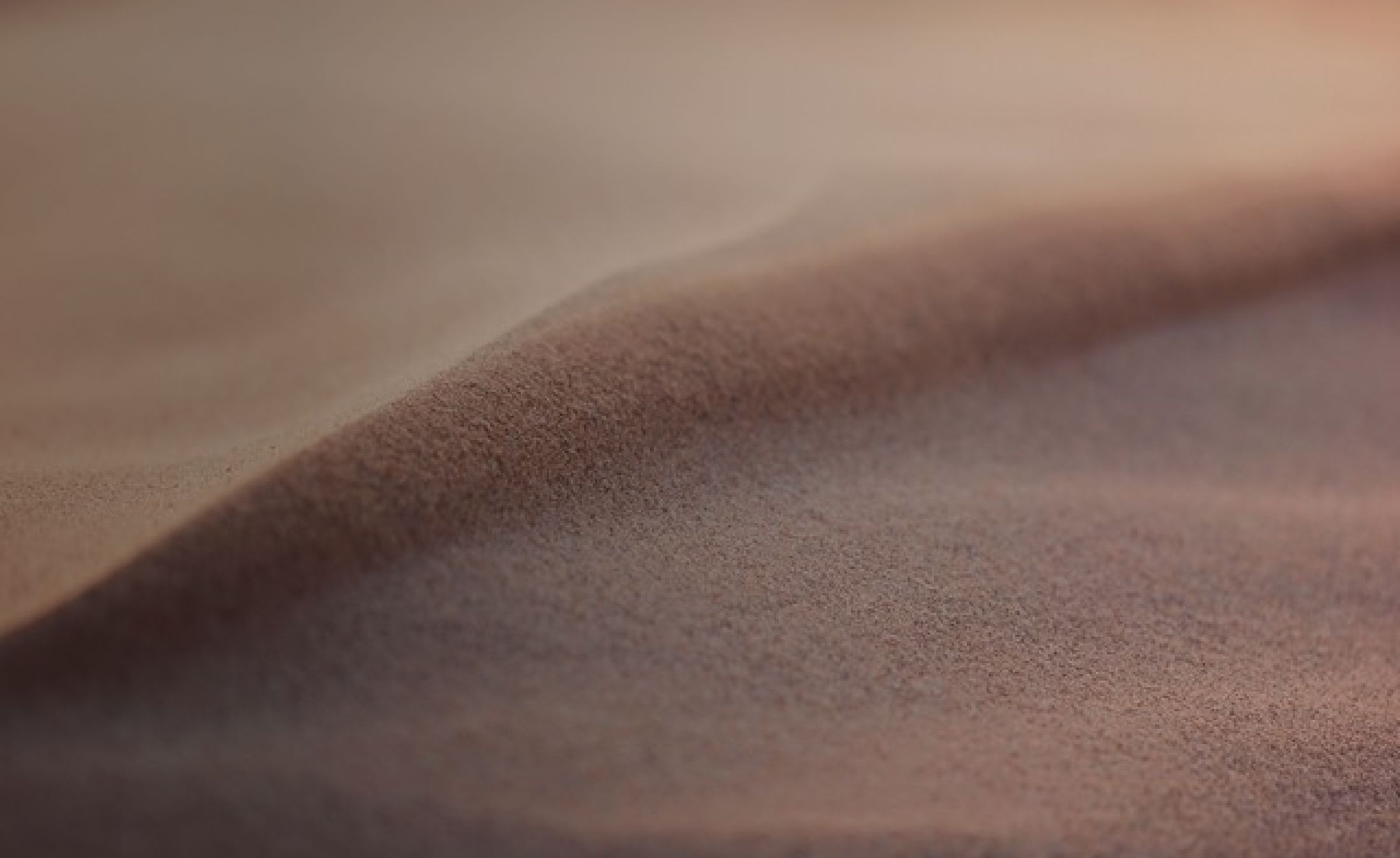 Close-up of smooth, undulating sand texture.