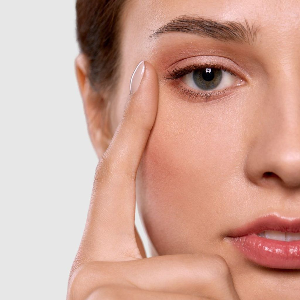Close-up of a woman touching her eye.