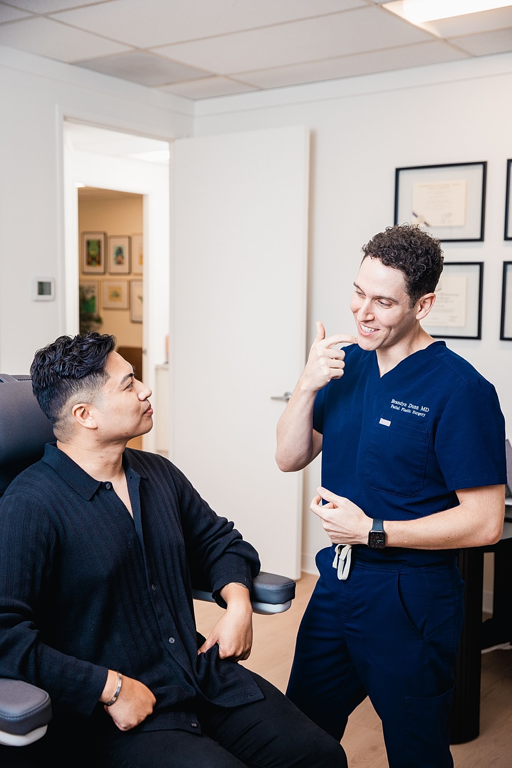 Doctor performing skin treatment on patient.