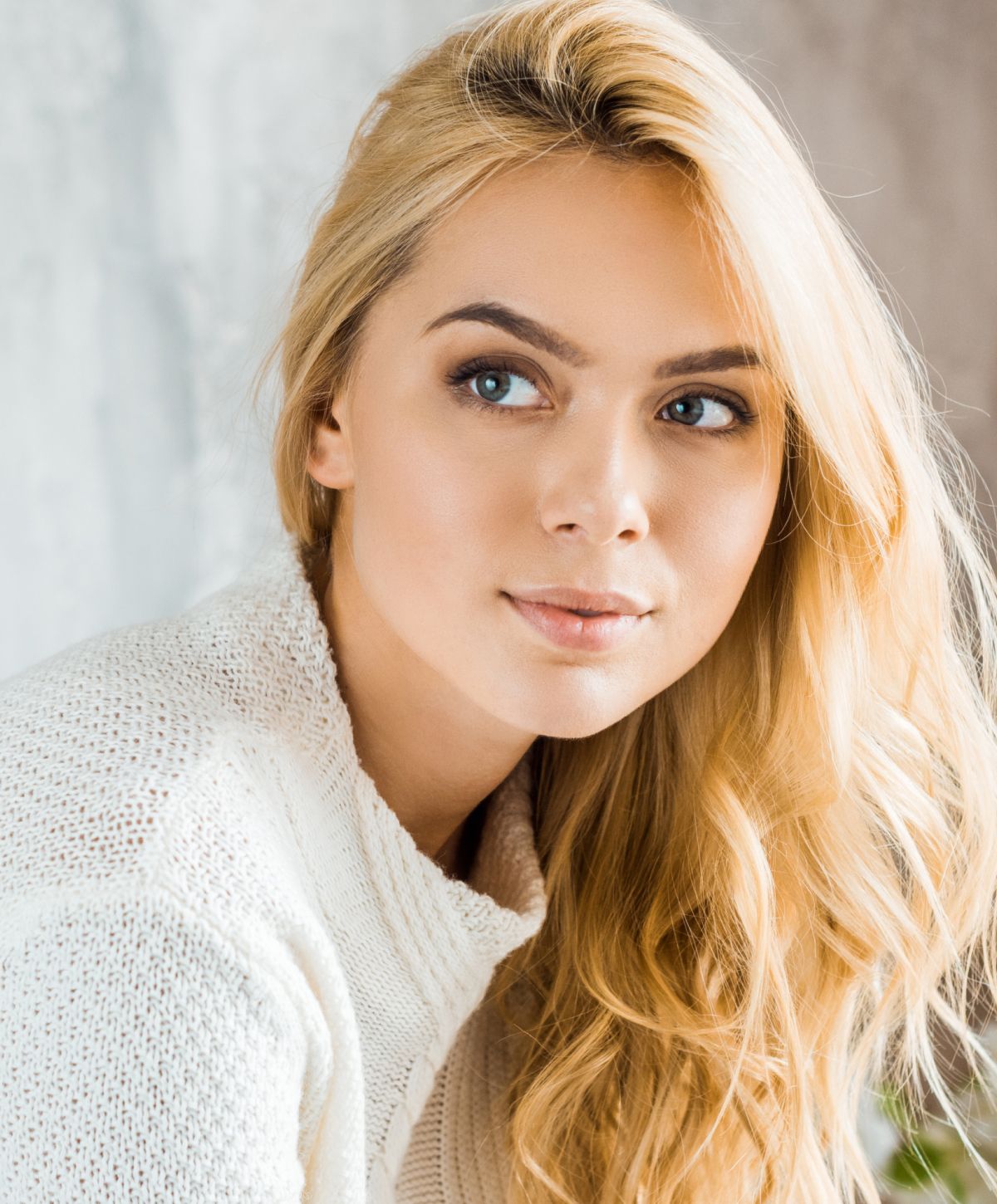 Smiling professional in black scrubs with crossed arms.