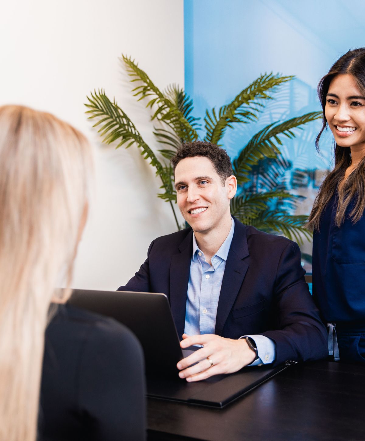 Patient consultation with smiling healthcare professional.