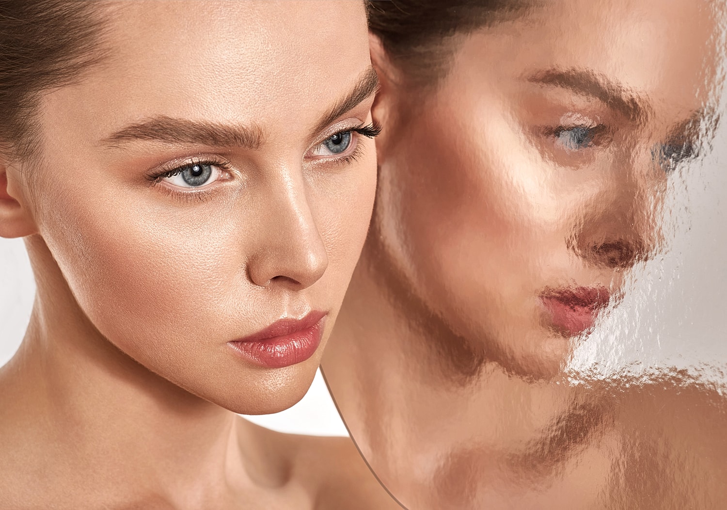 Model's face with blurred reflection background.