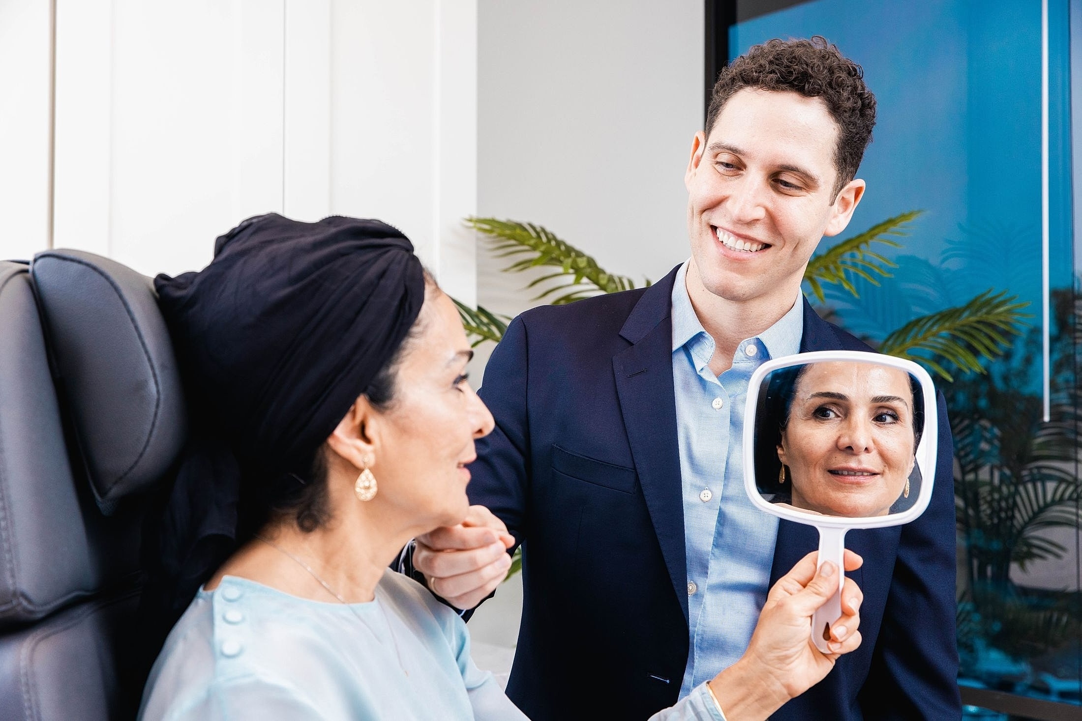 Doctor showing patient her reflection in mirror.