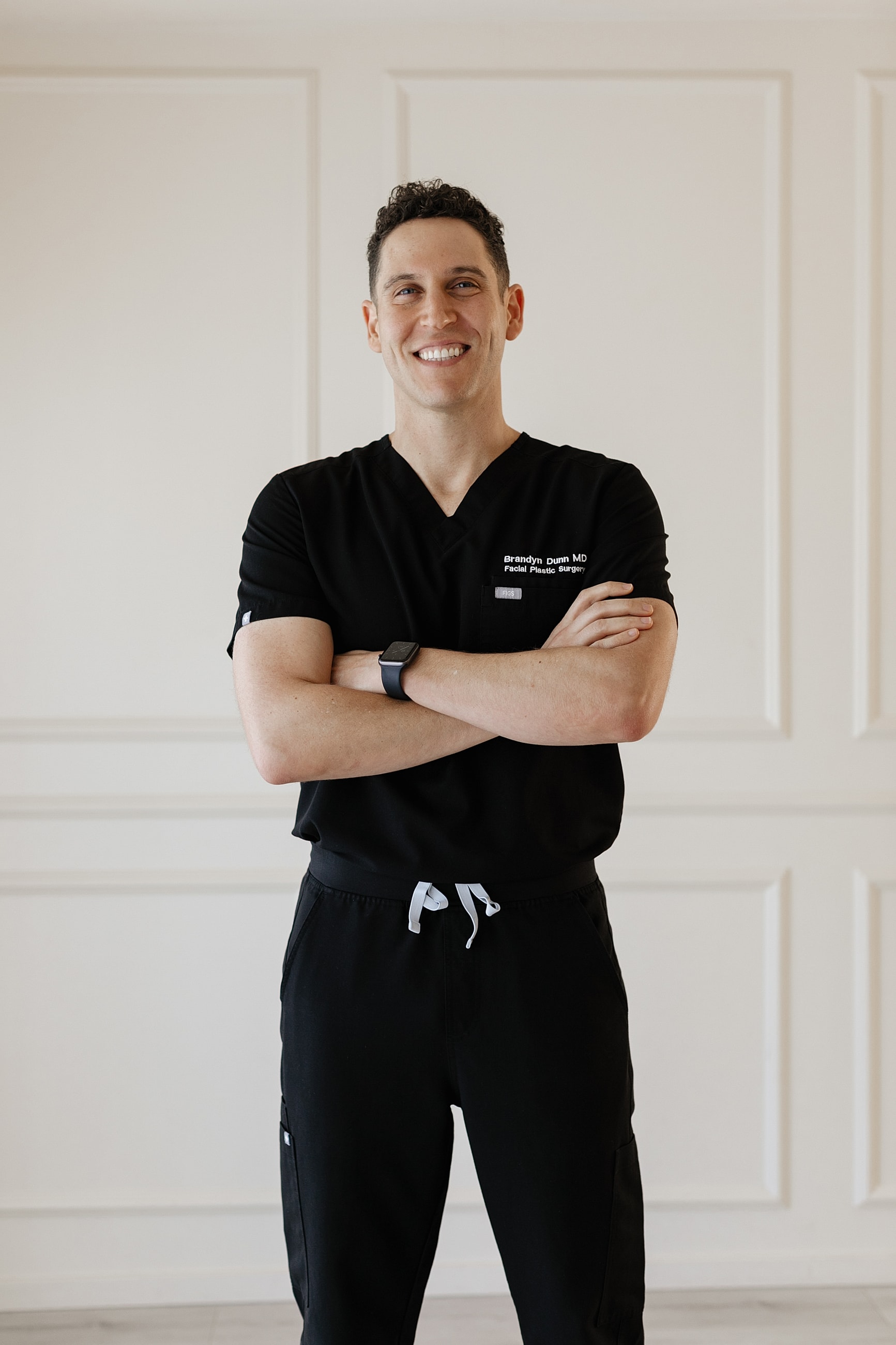 Smiling man in a suit, professional setting.